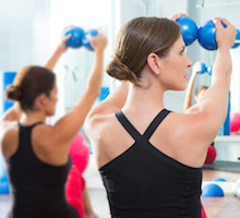 Pilates toning ball in women fitness class, yoga and fitness